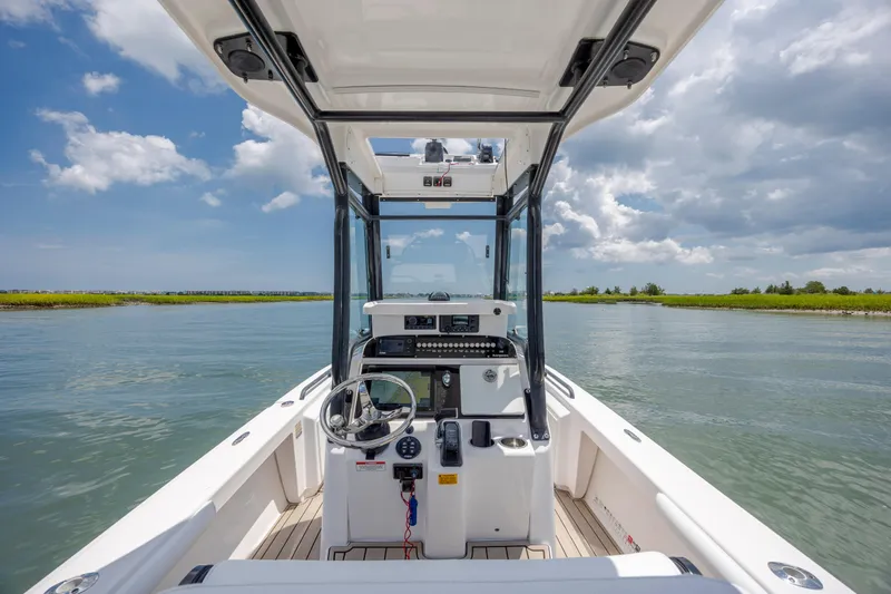 Slide: The Image of 2015 Everglades 243 Center Console boat on calm water under a partly cloudy sky. - 14
