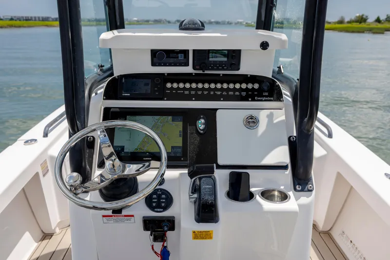 Slide: The Image of 2015 Everglades 243 Center Console boat dashboard with steering wheel and navigation system. - 15