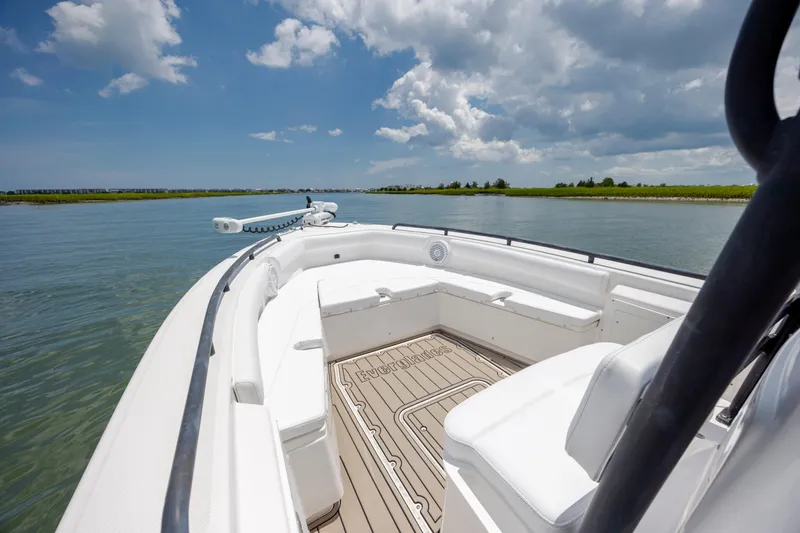 Slide: The Image of 2015 Everglades 243 Center Console boat on calm water under a partly cloudy sky. - 17