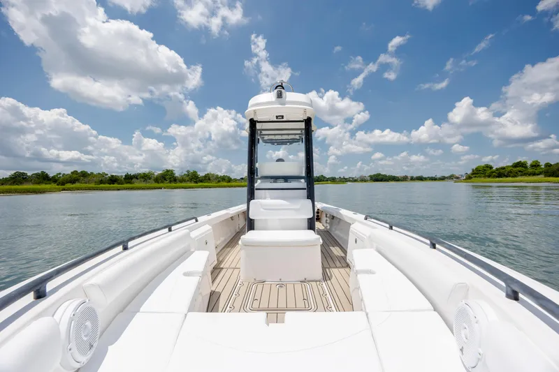 Slide: The Image of 2015 Everglades 243 Center Console boat on calm water under a blue sky. - 19