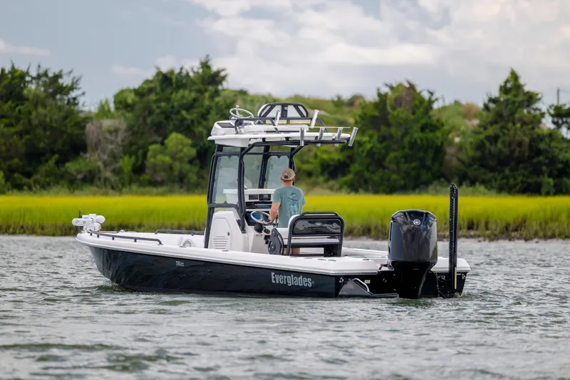 Slide: The Image of 2015 Everglades 243 Center Console boat cruising on a scenic waterway. - 2
