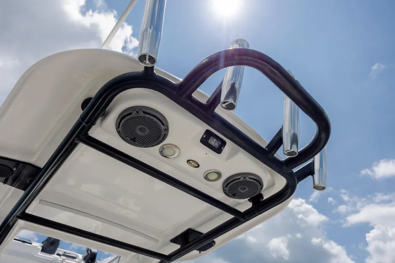 Slide: The Image of 2015 Everglades 243 Center Console boat speakers and rod holders under sunny sky. - 23