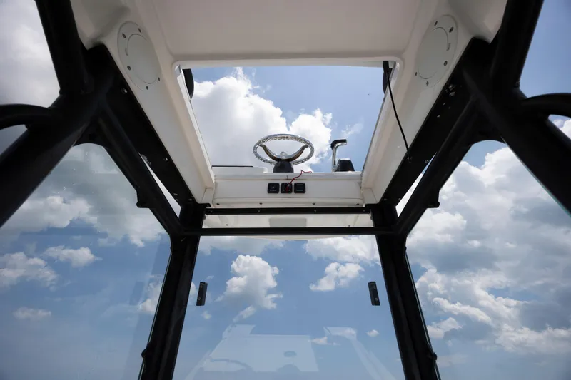 Slide: The Image of Interior view of 2015 Everglades 243 Center Console boat against a cloudy sky. - 27