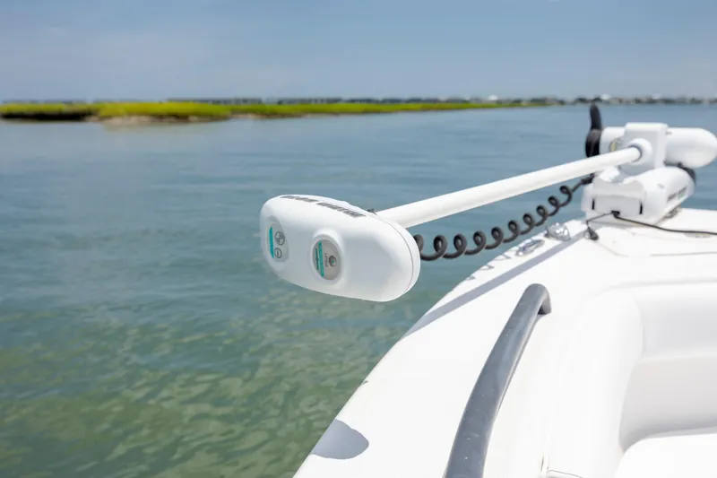 Slide: The Image of 2015 Everglades 243 Center Console boat with trolling motor on calm water. - 29