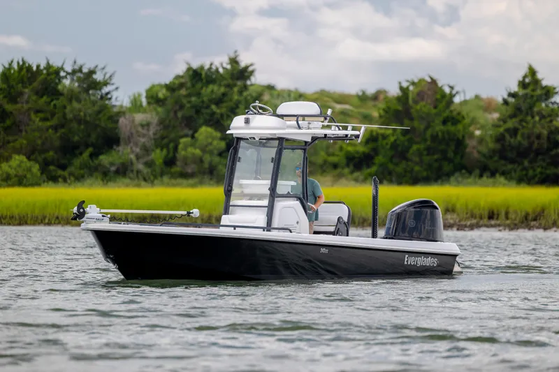 Slide: The Image of 2015 Everglades 243 Center Console boat cruising on a scenic waterway. - 3