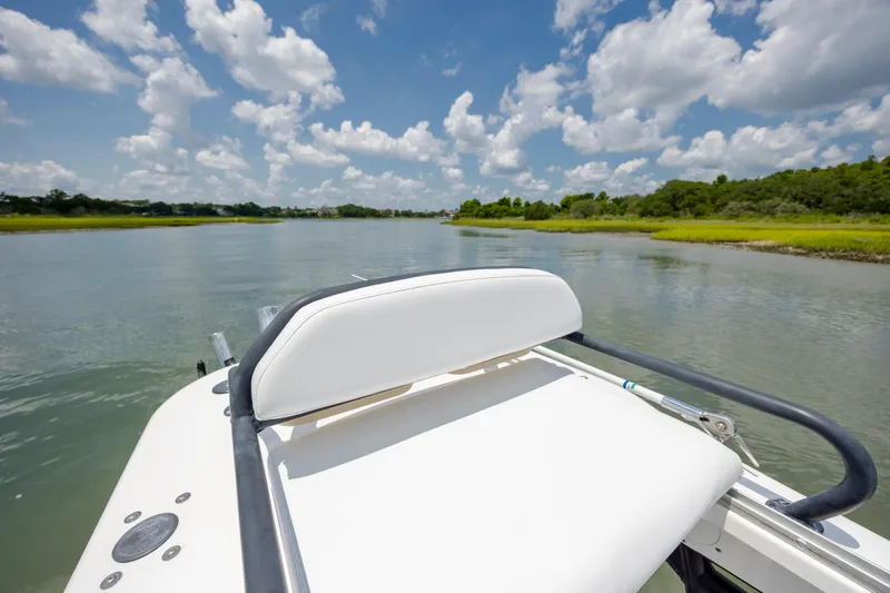 Slide: The Image of 2015 Everglades 243 Center Console boat on a serene river under a cloudy sky. - 30