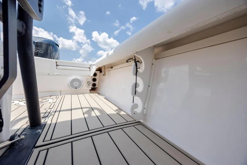 Slide: The Image of 2015 Everglades 243 Center Console boat interior with Yamaha engine, featuring sleek deck design. - 31