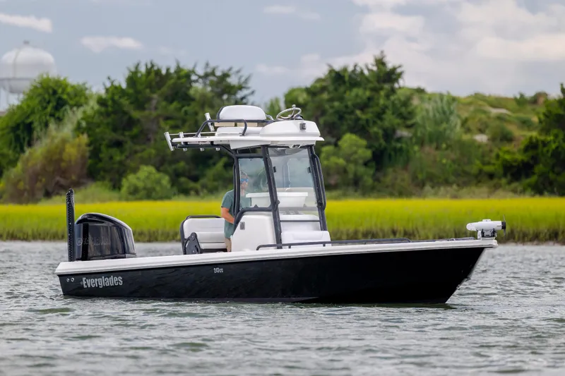 Slide: The Image of 2015 Everglades 243 Center Console boat on water, surrounded by lush greenery. - 4