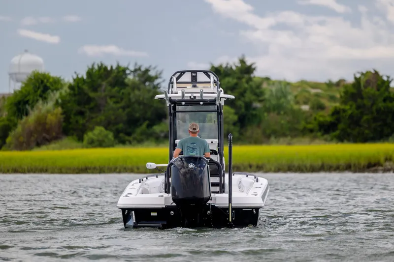 Slide: The Image of 2015 Everglades 243 Center Console boat cruising on a scenic waterway. - 5