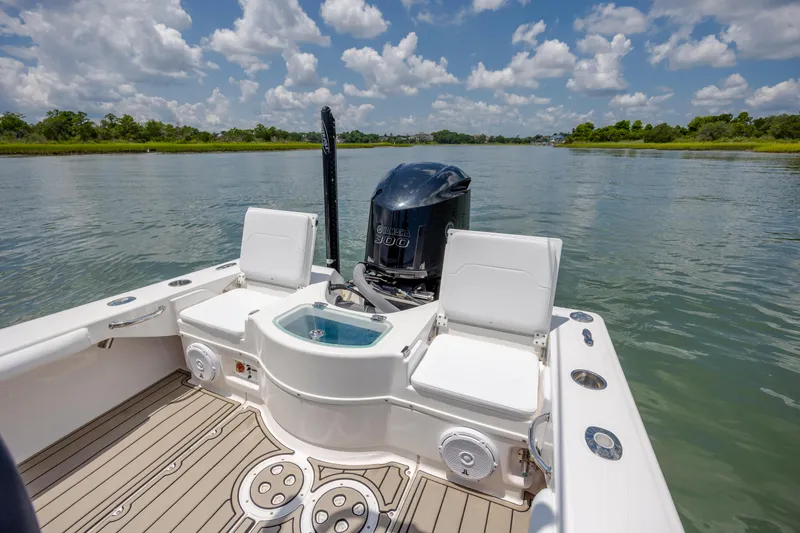 Slide: The Image of 2015 Everglades 243 Center Console boat on calm water under a cloudy sky. - 8