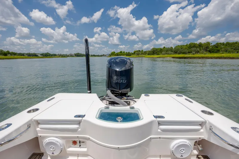Slide: The Image of 2015 Everglades 243 Center Console boat on calm water, featuring Yamaha 300 engine. - 9