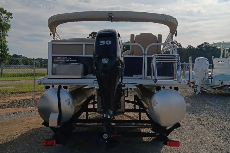 Slide: The Image of 2025 Sun Tracker Bass Buggy 16 XL Select pontoon boat with Mercury 50 engine, rear view. - 4