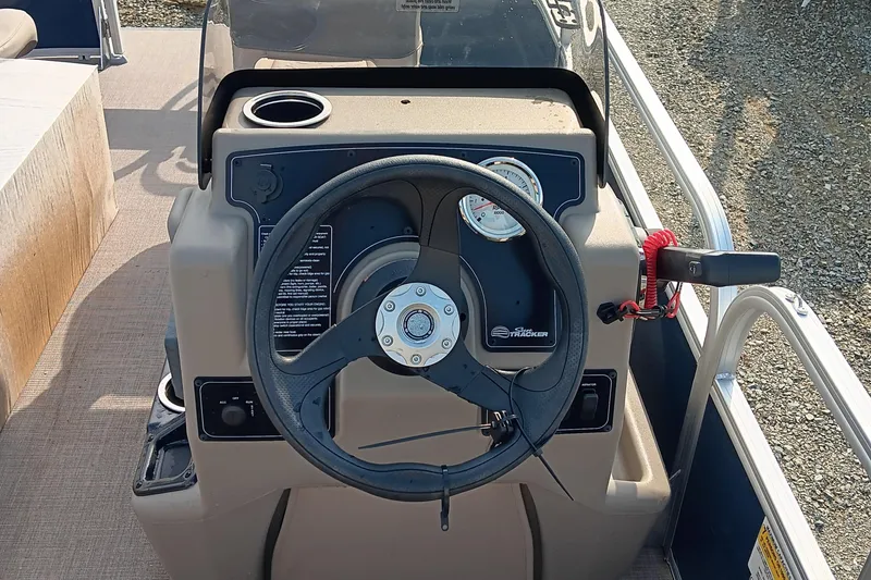 Slide: The Image of 2025 Sun Tracker Bass Buggy 16 XL Select steering console with gauges and controls. - 8