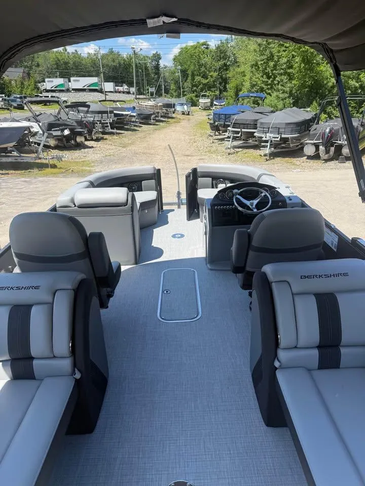 Slide: The Image of 2025 Berkshire 22RFX CTS pontoon boat interior with seating and steering wheel. - 4