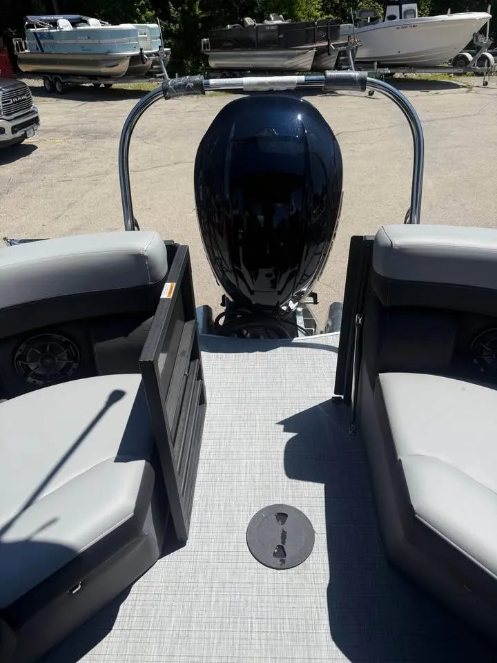 Slide: The Image of 2025 Berkshire 22RFX CTS pontoon boat interior with motor and seating. - 5