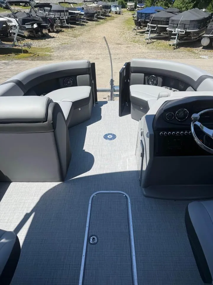 Slide: The Image of Interior of 2025 Berkshire 22RFX CTS pontoon boat with gray seating and steering console. - 6
