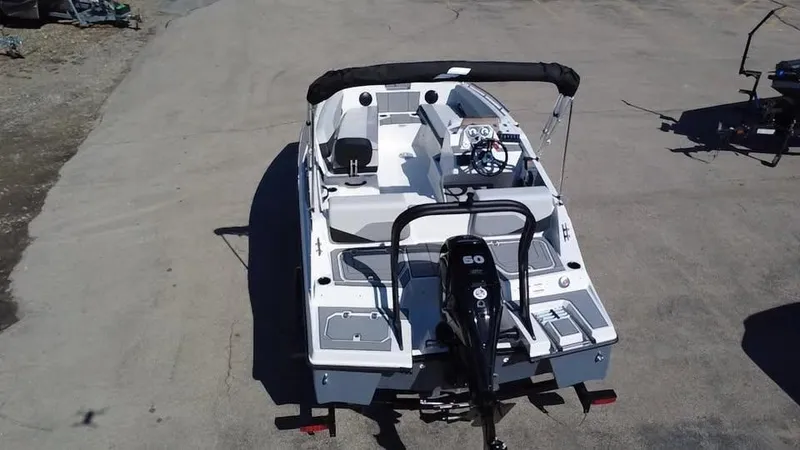 Slide: The Image of 2025 Starcraft SV 16 OB boat with outboard motor, viewed from above on a paved surface. - 4
