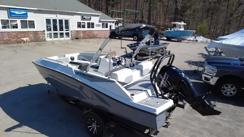 Slide: The Image of 2025 Starcraft SV 16 OB boat on trailer in marina parking lot. - 5