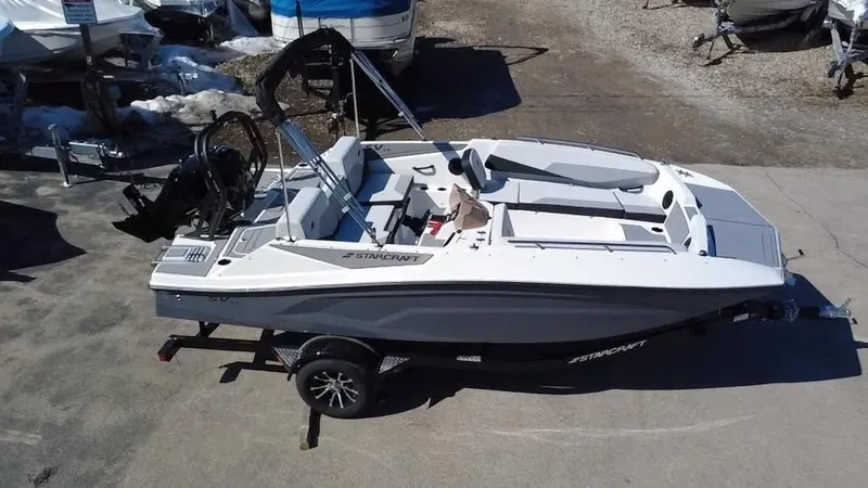 Slide: The Image of 2025 Starcraft SV 16 OB boat on trailer, parked outdoors. - 7