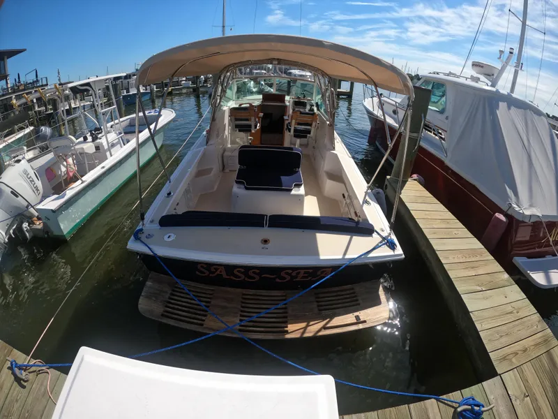 Slide: The Image of 2005 Hunt Yachts Surfhunter 25 docked at marina under clear skies. - 6