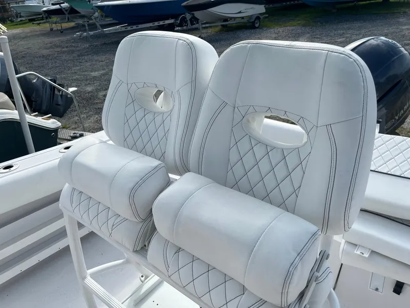Slide: The Image of 2021 Sportsman Heritage 211 Center Console boat with white cushioned seating. - 10