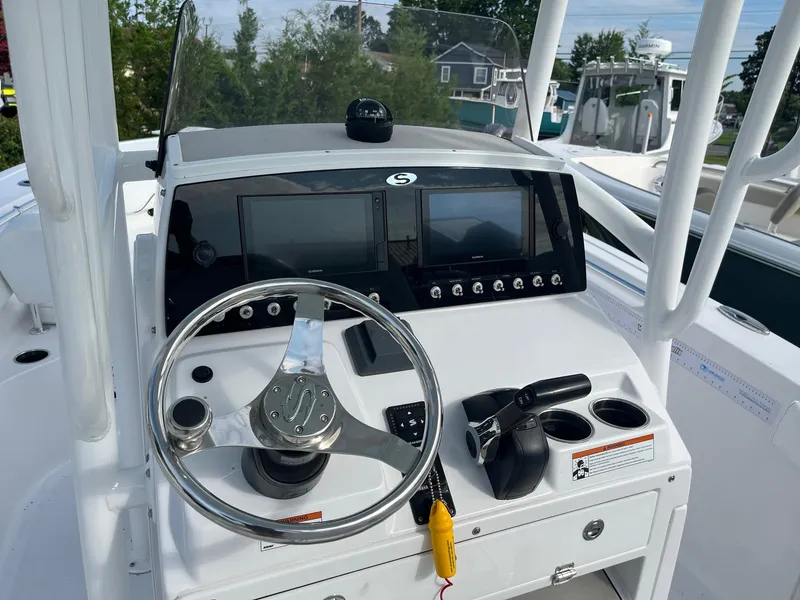 Slide: The Image of 2021 Sportsman Heritage 211 Center Console dashboard with steering wheel and navigation screens. - 11
