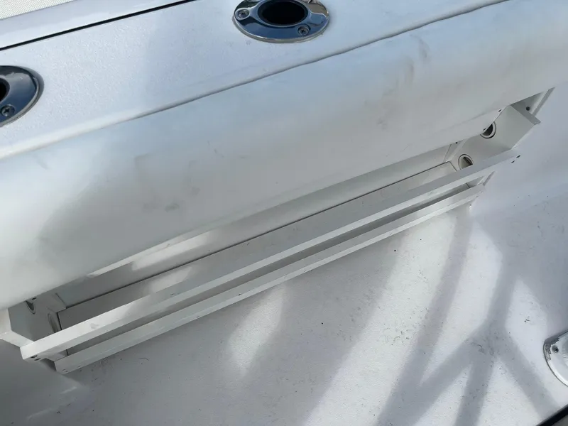 Slide: The Image of 2021 Sportsman Heritage 211 Center Console boat interior with rod holders and seating. - 12