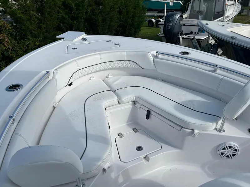 Slide: The Image of 2021 Sportsman Heritage 211 Center Console boat with white cushioned seating area. - 15