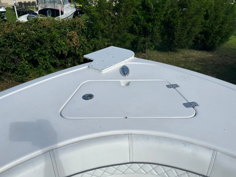 Slide: The Image of 2021 Sportsman Heritage 211 Center Console boat deck with storage hatch. - 16