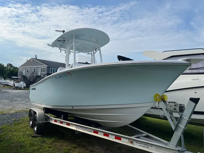 Slide: The Image of 2021 Sportsman Heritage 211 Center Console boat on trailer, parked outdoors. - 3