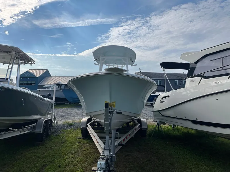 Slide: The Image of 2021 Sportsman Heritage 211 Center Console boat on trailer, flanked by other boats. - 4
