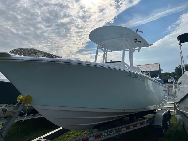 Slide: The Image of 2021 Sportsman Heritage 211 Center Console boat on trailer under cloudy sky. - 5