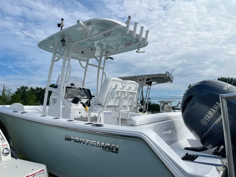 Slide: The Image of 2021 Sportsman Heritage 211 Center Console boat with Yamaha engine, under a cloudy sky. - 6