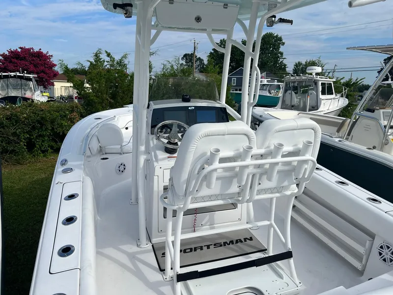 Slide: The Image of 2021 Sportsman Heritage 211 Center Console boat with white seating and steering console. - 8