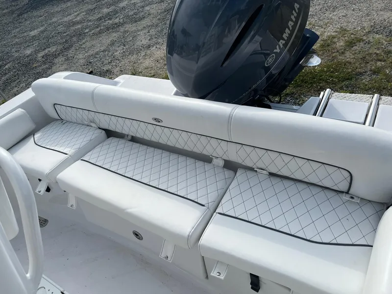 Slide: The Image of 2021 Sportsman Heritage 211 Center Console boat with white cushioned seating and Yamaha engine. - 9