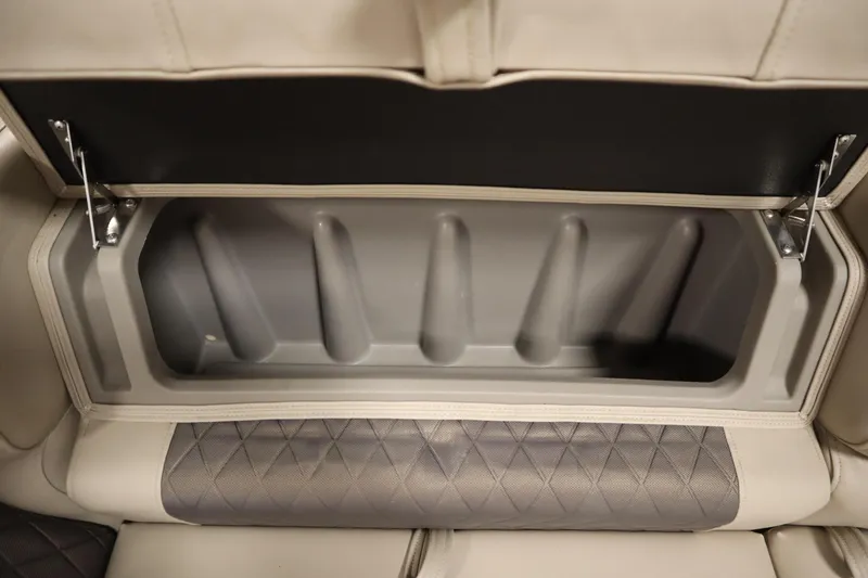 Slide: The Image of Storage compartment in 2023 Tracker 20 DLX PARTY BARGE boat, featuring cushioned seating. - 13