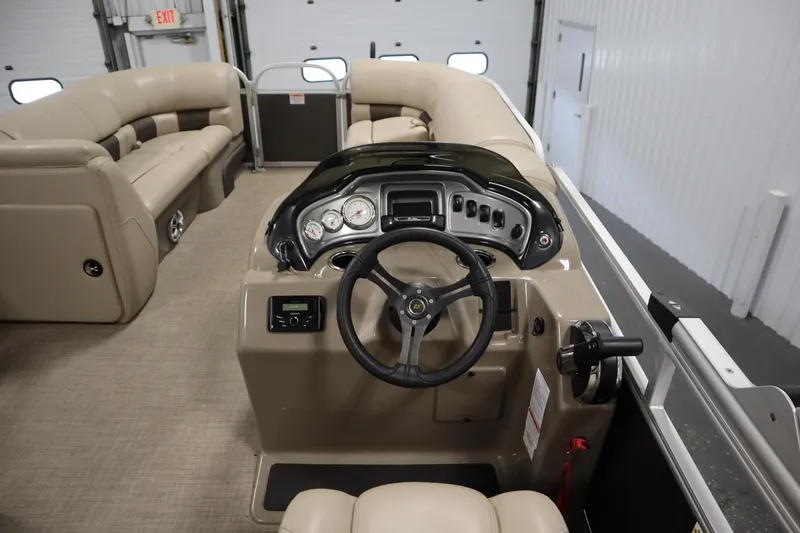 Slide: The Image of 2023 Tracker 20 DLX PARTY BARGE interior with steering console and seating. - 24