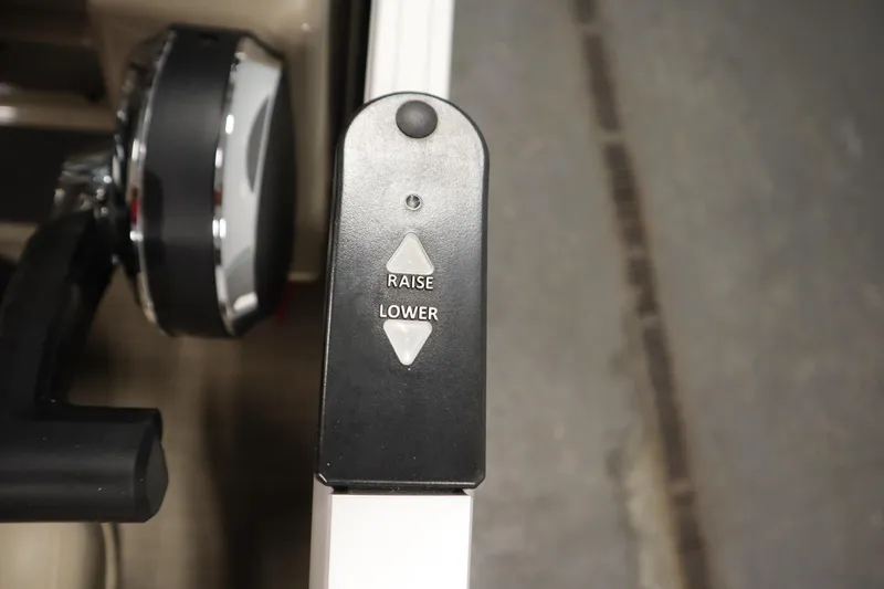 Slide: The Image of Control panel on 2023 Tracker 20 DLX PARTY BARGE with raise and lower buttons. - 29