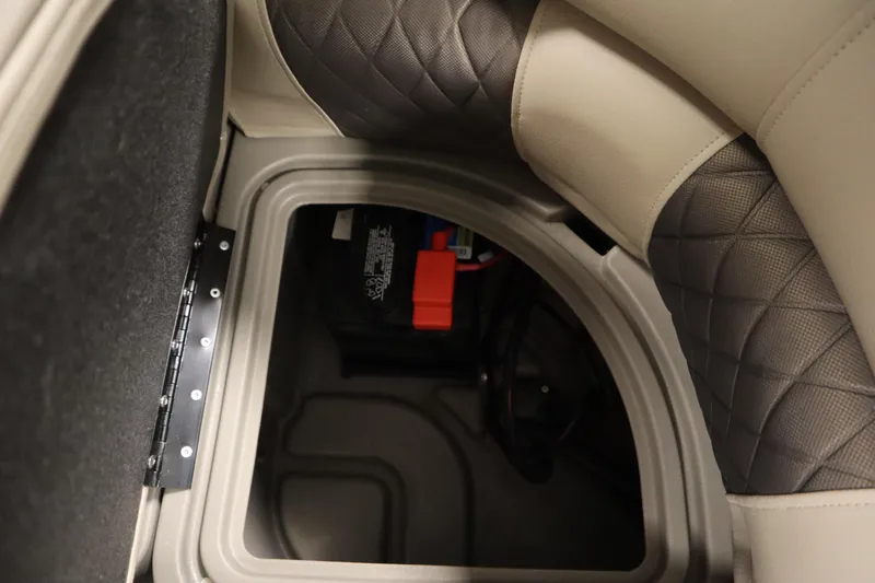 Slide: The Image of 2023 Tracker 20 DLX PARTY BARGE storage compartment with quilted upholstery and battery. - 36