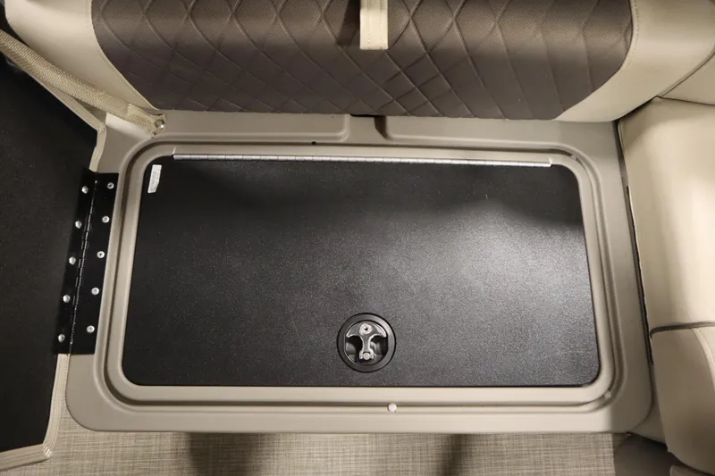 Slide: The Image of 2023 Tracker 20 DLX PARTY BARGE storage compartment with cushioned seating and secure latch. - 38