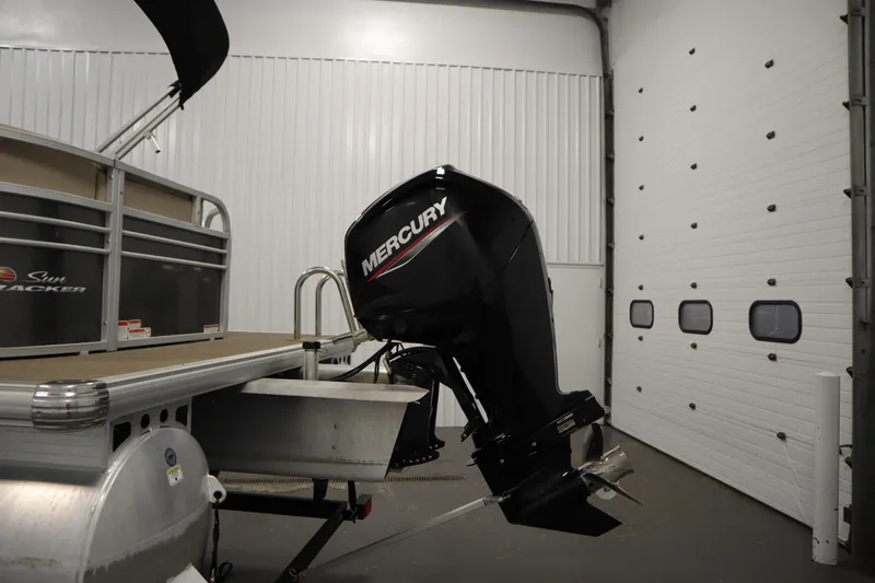 Slide: The Image of 2023 Tracker 20 DLX PARTY BARGE with Mercury outboard motor in a garage. - 42