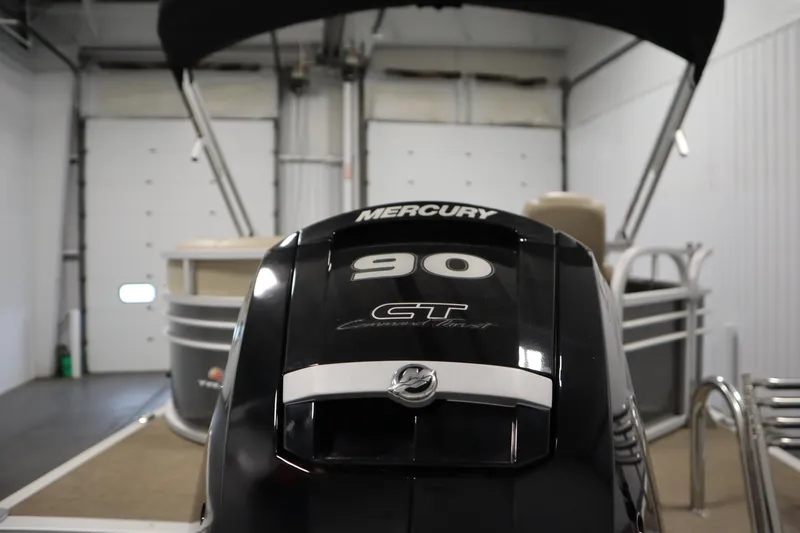 Slide: The Image of 2023 Tracker 20 DLX PARTY BARGE with Mercury 90 GT engine in a garage. - 44