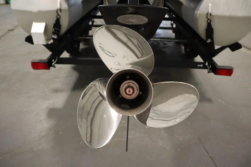 Slide: The Image of Propeller of 2023 Tracker 20 DLX PARTY BARGE pontoon boat in a garage setting. - 45