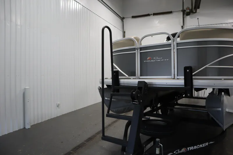 Slide: The Image of 2023 Tracker 20 DLX PARTY BARGE pontoon boat in storage facility. - 47
