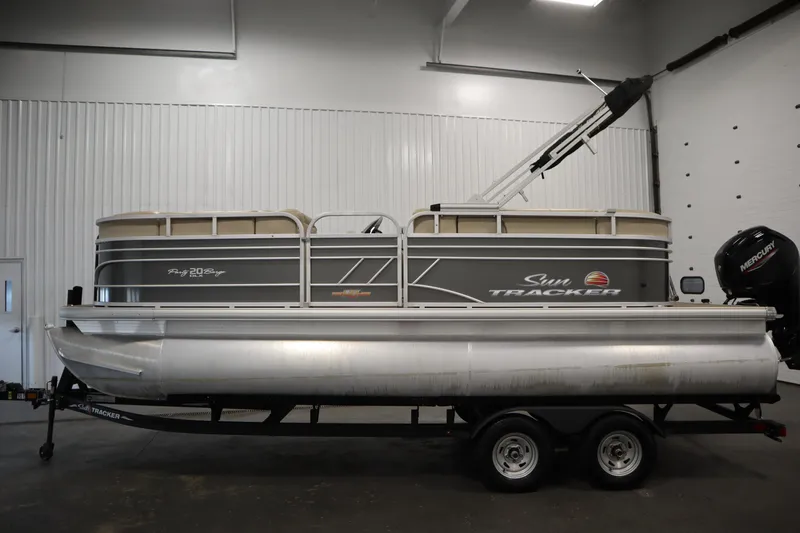 Slide: The Image of 2023 Tracker 20 DLX PARTY BARGE pontoon boat in indoor showroom. - 8