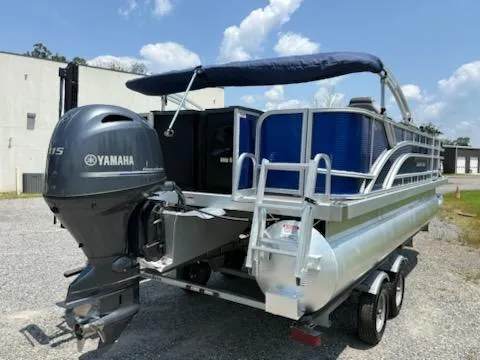 Slide: The Image of 2024 Bennington 20SVF pontoon boat with Yamaha motor, parked outdoors under a blue sky. - 4