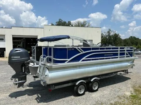 Slide: The Image of 2024 Bennington 20SVF pontoon boat with Yamaha motor, parked outdoors under a blue sky. - 5