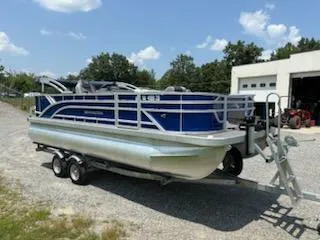 Slide: The Image of 2024 Bennington 20SVF pontoon boat on trailer, parked outdoors. - 6