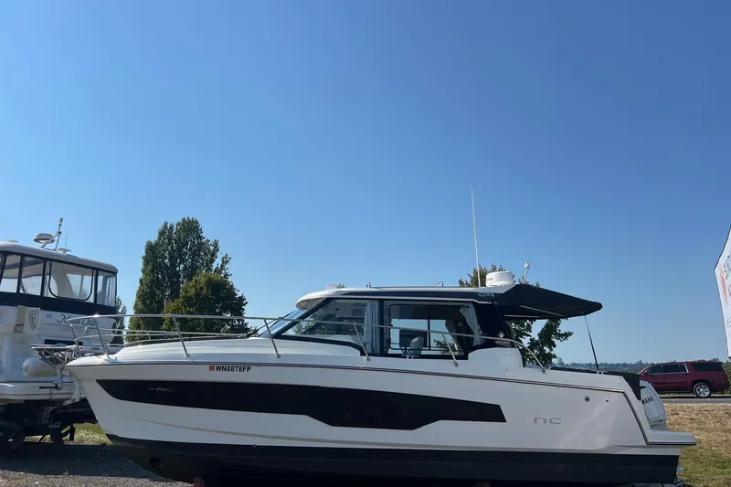 Slide: The Image of 2023 Jeanneau NC Weekender 1095 boat on display under clear blue sky. - 15