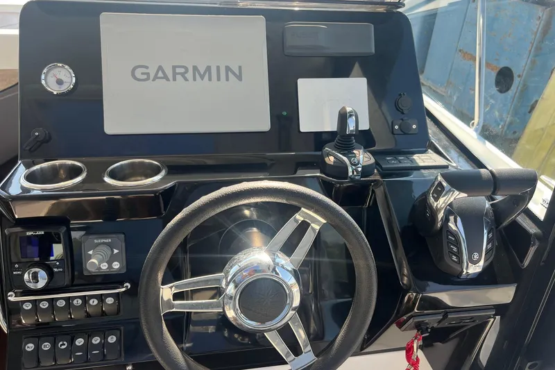 Slide: The Image of Cockpit of 2023 Jeanneau NC Weekender 1095 with Garmin navigation system and controls. - 27